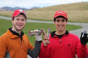 Young golfers holding Kind Bars