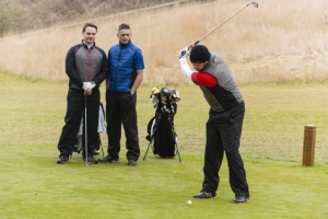 golfers teeing off cold weather gear